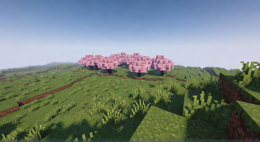 como encontrar el bioma de cerezo en minecraft, Vista desde una colina buscando un bioma de cerezo en Minecraft.