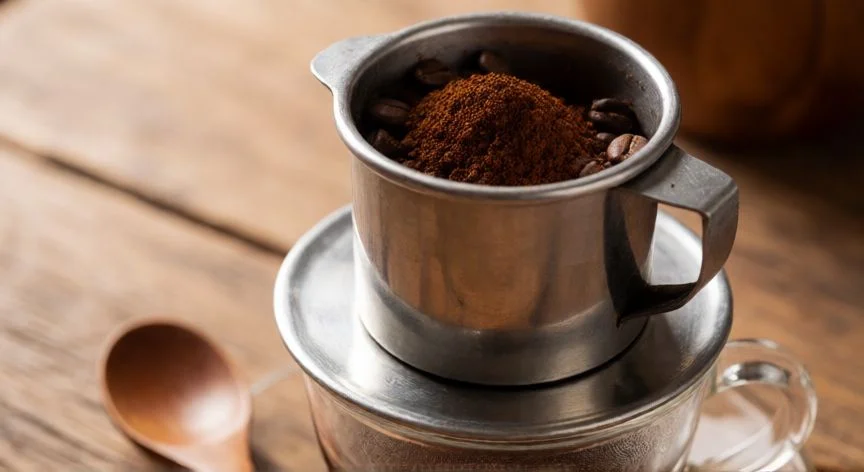 Cafetera de goteo vietnamita con café molido listo para preparar
