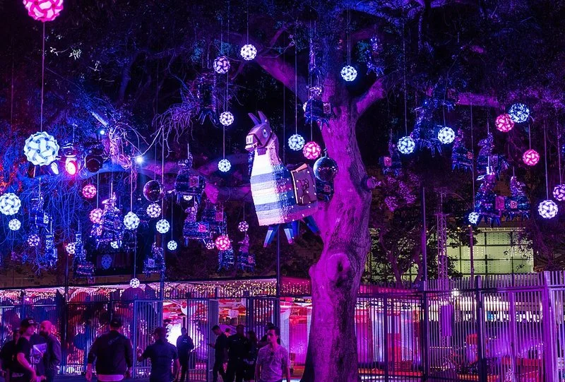 Piñatas y llamas de botín iluminadas en un árbol navideño, decoración Fortnite