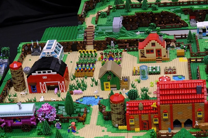 Maqueta de granja de Stardew Valley con granero, invernadero, silos y parcelas de cultivos