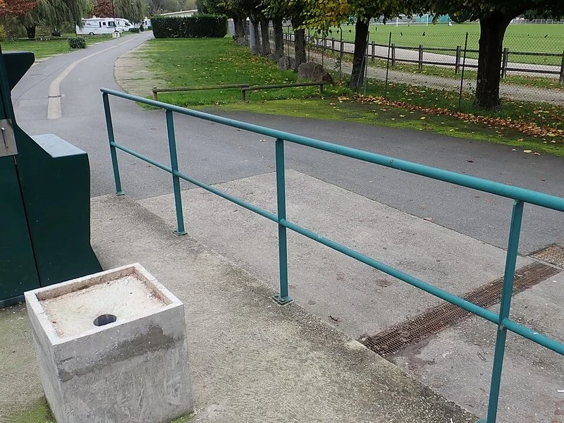 Point de vidange pour eaux noires dans une aire de camping-cars, avec toilettes et rampe