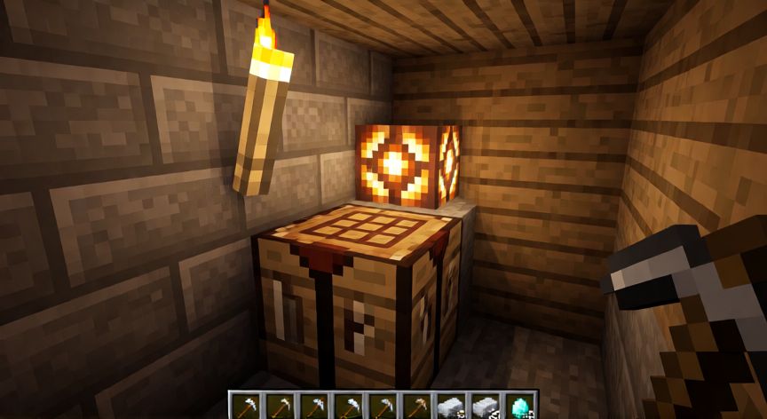 que es minecraft y como se juega, Interior de una base subterránea en Minecraft con mesa de trabajo, herramientas y lámparas de redstone